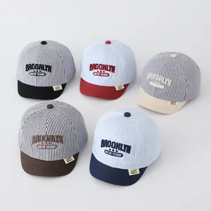 Detailed set of five striped baby baseball caps with Brooklyn New York embroidery