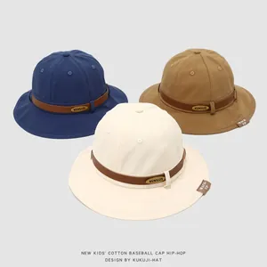 Detail of cotton kids bucket hats with leather trim and metal logo in multiple colors