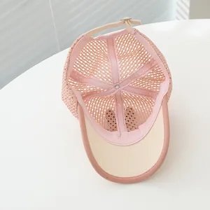 Detail of pink mesh baseball cap showing breathable holes and adjustable back strap