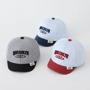 Detail of baby striped baseball caps with Brooklyn embroidery and soft short brims