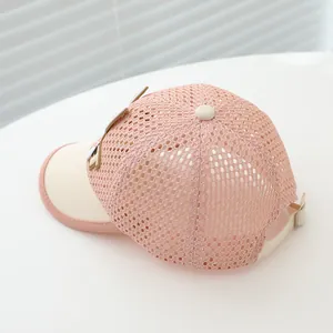Detail of pink mesh kids baseball cap showing breathable texture and adjustable metal buckle