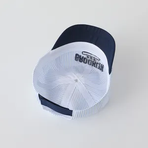 Detail view of cotton baby baseball cap with embroidered Brooklyn text and striped lining