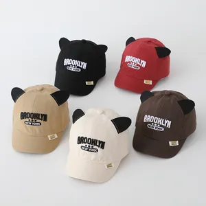 Detail of baby baseball caps with 3D cat ears and Brooklyn embroidery in five colors
