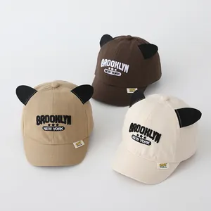 Three children's baseball caps with cat ears in khaki, brown, and cream white colors