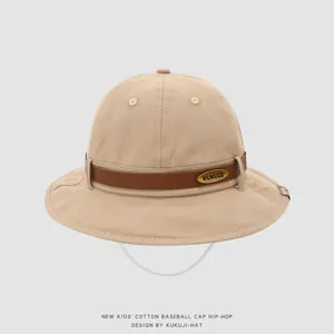 Detail of khaki kids sun hat with leather band, gold brand plate, and windproof strap