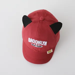 Detail of red kids baseball cap with cat ears and Brooklyn white 3D embroidery