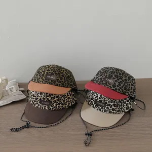 Detail of kids leopard print baseball caps with adjustable wind ropes and Dream patch