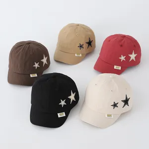 Detailed view of colorful cotton baseball caps for toddlers featuring star embroidery