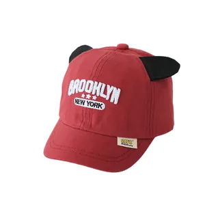 Red kids baseball cap with devil horns and Brooklyn New York embroidery on white background