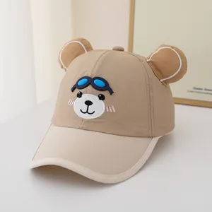 Detail of child baseball cap with bear ears and blue 3D glasses embroidery on khaki fabric