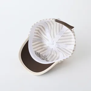 Internal view of striped baby baseball cap with reinforced seams and adjustable strap