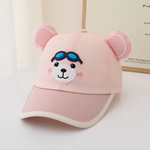 Detail of pink kids baseball cap featuring 3D ears and cartoon puppy embroidery with goggles