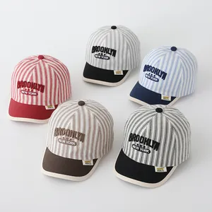 Detail view of colorful striped baseball caps for kids with Brooklyn embroidery set