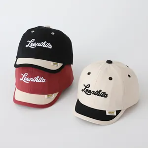 Close-up of cotton baseball caps with Leonikita letter embroidery and canvas texture