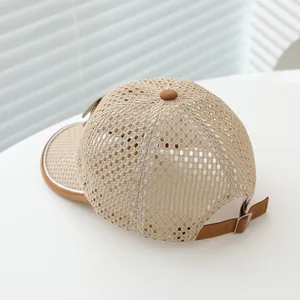 Close-up of the breathable mesh texture and adjustable metal strap on a khaki baseball cap