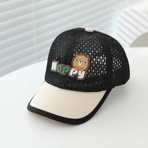 Close-up of breathable mesh fabric and cartoon bear happy patch on the kids sun hat