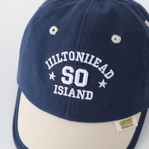 Detail of navy and beige baseball cap with Hiltonhead Island embroidery and woven label