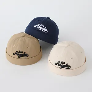 Three Chinese-style children's Miki hats in navy, khaki, and beige with Los Angeles embroidery