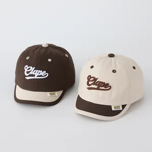 Close-up of cotton baby baseball caps with embroidered letters and high-quality stitching