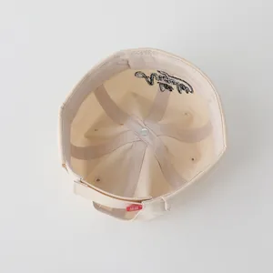 Detail of baby landlord cap interior featuring reinforced seams and elegant embroidery