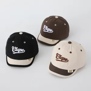 Detailed embroidery of Clape letters on three canvas baseball caps for children