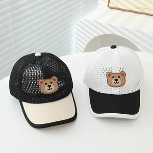 Close-up of kids summer mesh baseball caps with cute cartoon bear patches and breathable fabric