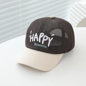 Dettaglio del tessuto a rete e del ricamo 3D HAPPY SCHOOL sul cappellino da bambino