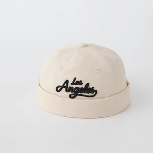 Detailed embroidery of Los Angeles script on a beige cotton canvas docker hat surface
