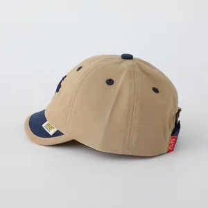 Detail of BOSTON baby baseball cap featuring contrast brim, stitching and woven labels