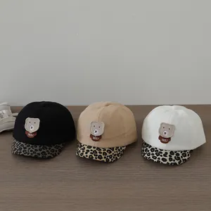 Detailed trio of kids baseball caps featuring bear patches and leopard print brims