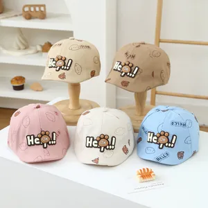 Detail of five assorted toddler caps with cartoon dog prints and 3D soft rubber badges
