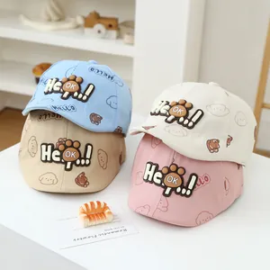 Detail of four colorful baby cotton baseball caps with bear prints and silicone patches