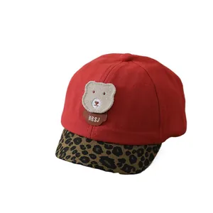 Infant red baseball cap featuring plush bear patch and leopard print brim detail