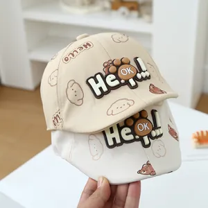 Detail of baby sun hats featuring cute bear prints and 3D Hello OK rubber patches