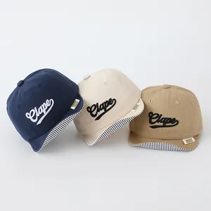 Toddler soft brim baseball hats in blue, beige, and khaki with Clape embroidery