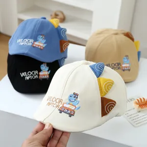 Detail view of four cotton kids caps with velociraptor embroidery and 3D triangle accents