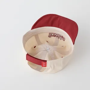 Detail view of cotton baby cap interior with Brooklyn embroidery and adjustable velcro strap