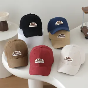 Collection of six cotton baseball caps with BAD BUSINESS embroidered patches in multiple colors