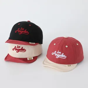 Close-up of kids soft brim baseball caps featuring Los Angeles embroidery and soft cotton