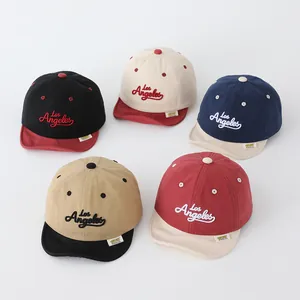 Detailed view of color-blocked kids baseball caps featuring Los Angeles embroidery