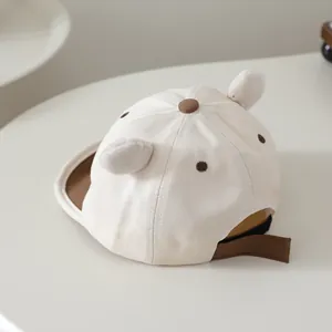 Detail of baby baseball cap with plush bear ears and polka dot embroidery on canvas