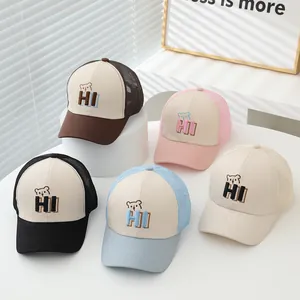 Detail of five-color mesh trucker caps for kids with 'HI' bear embroidery and breathable back