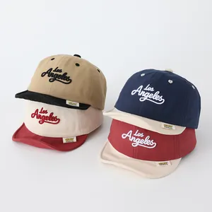 Detail of Los Angeles embroidery on multi-colored cotton baseball caps for kids