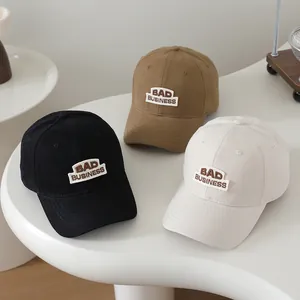 Set of kids baseball caps in black, khaki, and beige featuring BAD BUSINESS embroidery