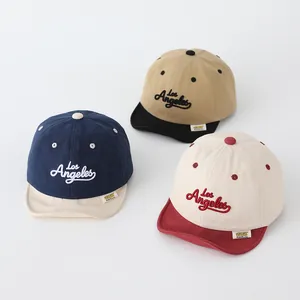 Detailed view of three cotton baseball caps with Los Angeles embroidery and soft brims