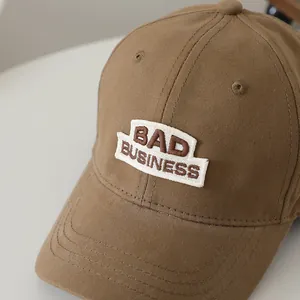 Brown cotton baseball cap with BAD BUSINESS embroidery and curved brim for kids