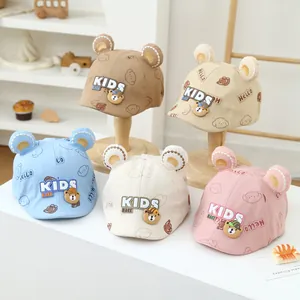 Detailed close-up of kids bear ear caps in five colors with cute cartoon patches