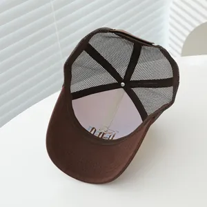 Detailed interior of brown mesh cap showing embroidery craftsmanship and inner reinforcement