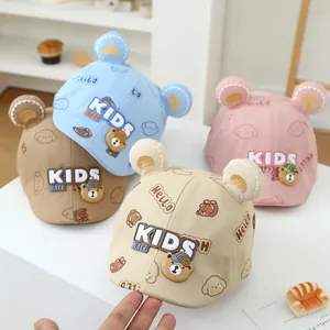 Detail of baby bear baseball caps in blue, pink, and beige with cute 3D ears and patches