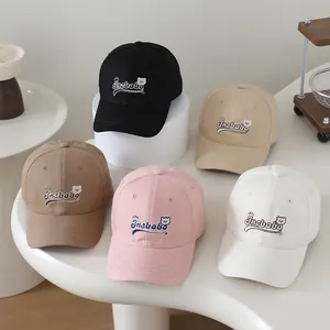 Detailed embroidery of cartoon bear and letters on multi-colored kids baseball caps